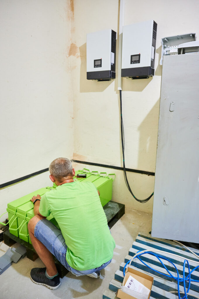 Technician installing a home battery and inverter at a Laguna Hills, CA home